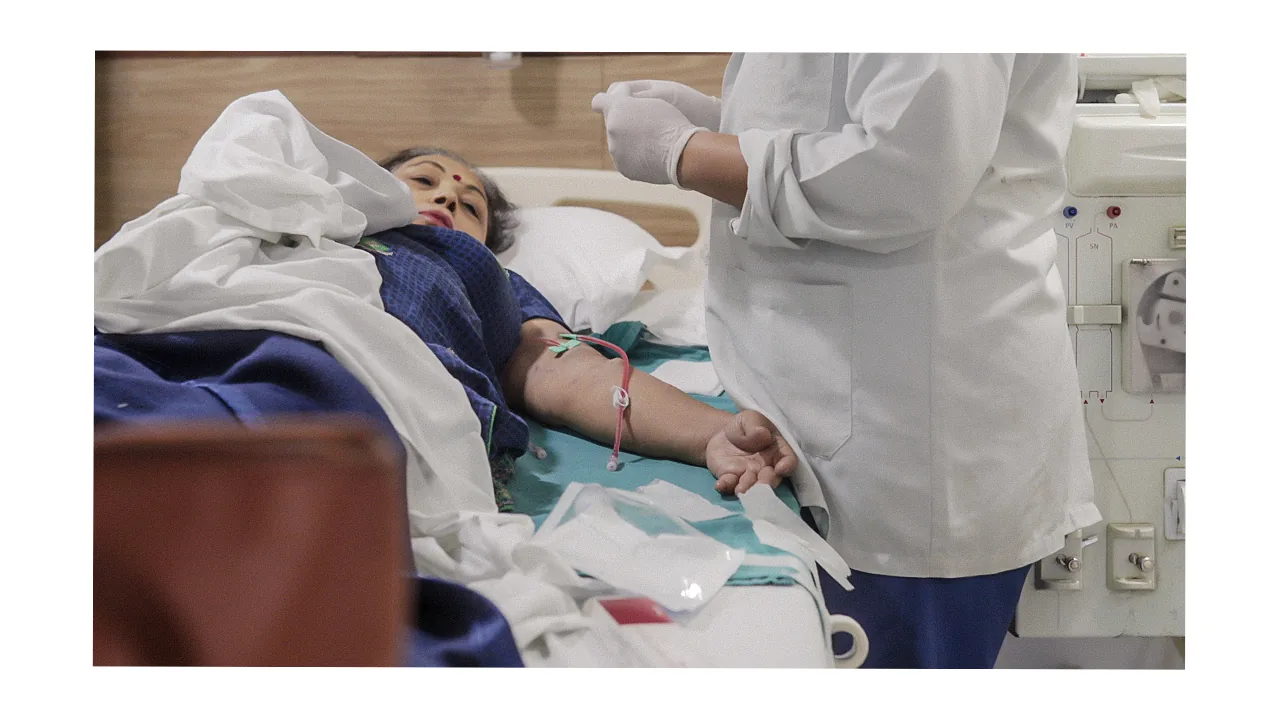 Doctor placing dialysis access on patient arm